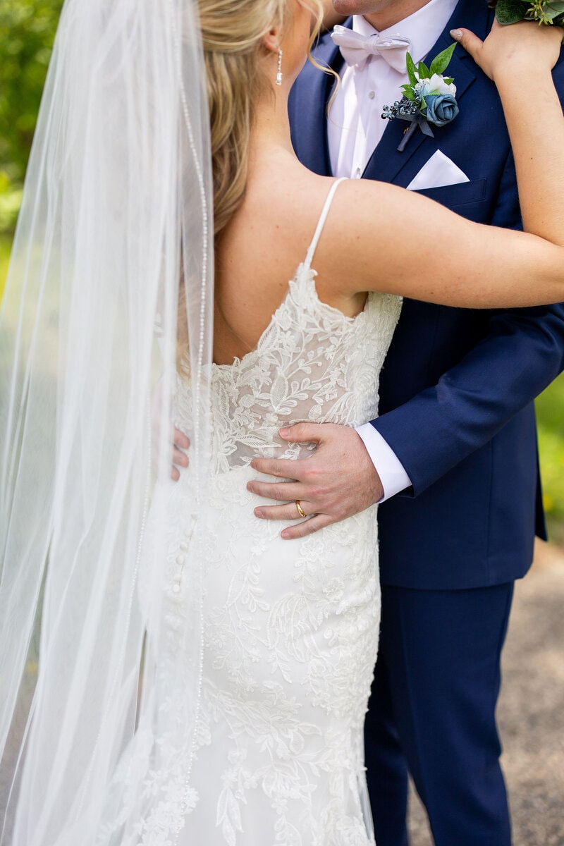 Bride trying on designer wedding gown during bridal appointment at Bridal Aisle Boutique, Osseo MN