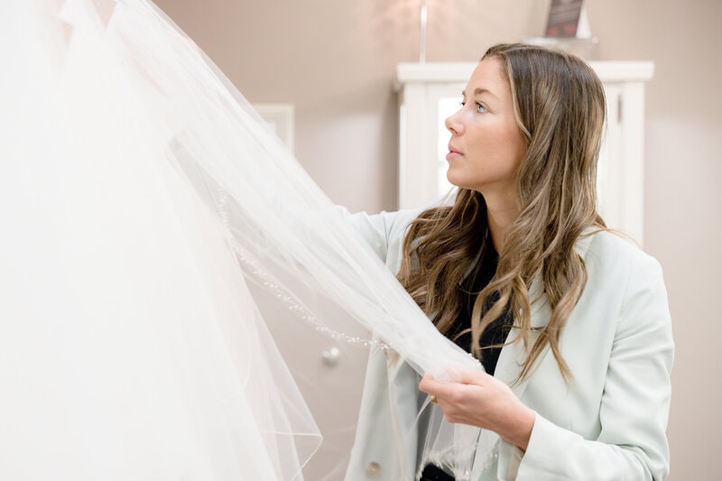 Bride during affordable budget bridal appointment — designer wedding dresses under $600, Minnesota
