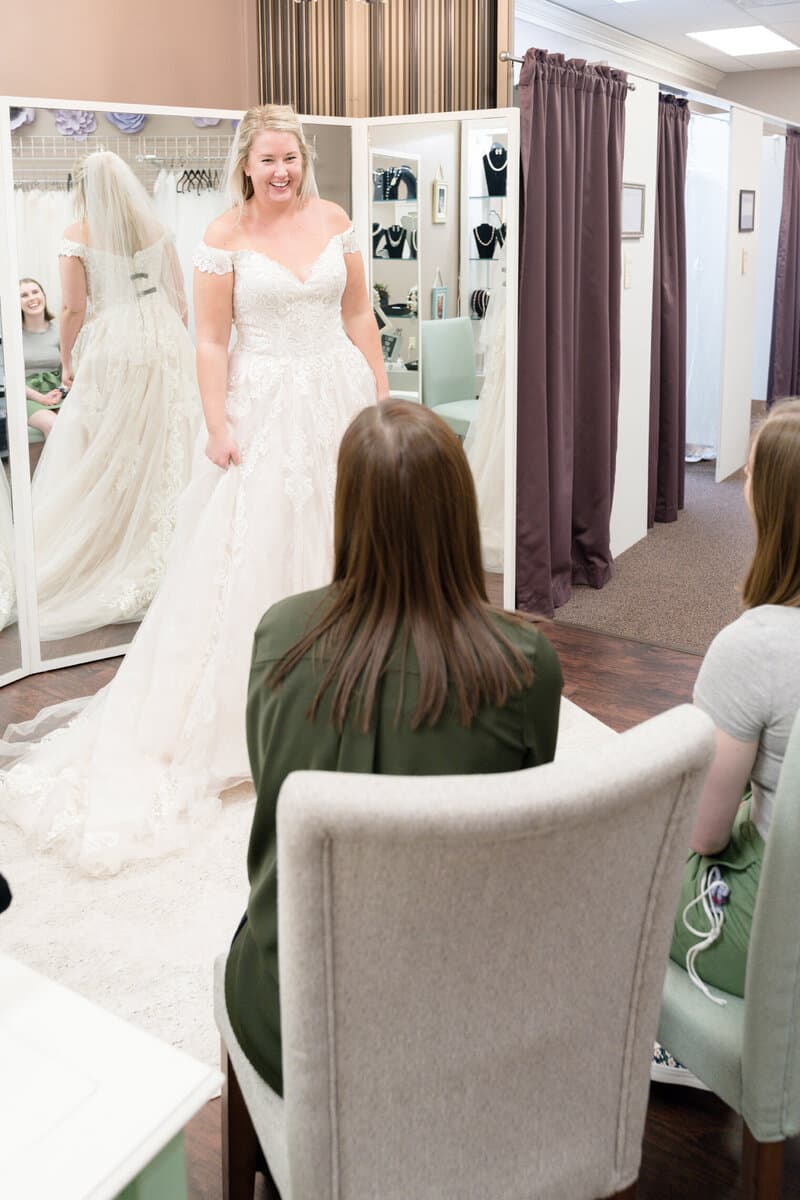 Personal bridal stylist helping bride choose a designer wedding dress — wedding dress shopping Minnesota